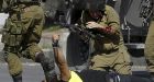 Israeli trooper lies wounded beside Palestinian knifeman who was shot dead
